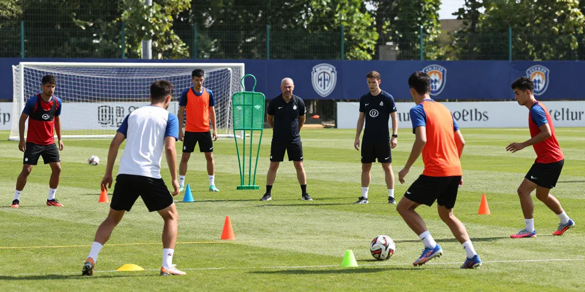 Soccer training session at https://media.upin.ac.id/ with players practicing and coach guiding for match preparation.